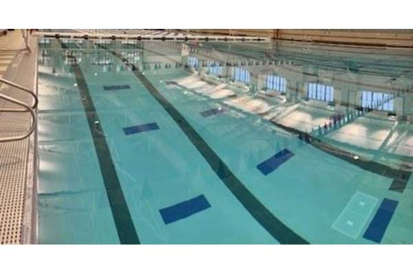 A large indoor swimming pool with multiple lanes.